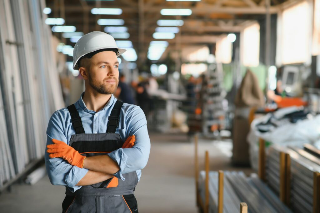 Factory for aluminum and PVC windows and doors production. Manual worker assembling PVC windows
