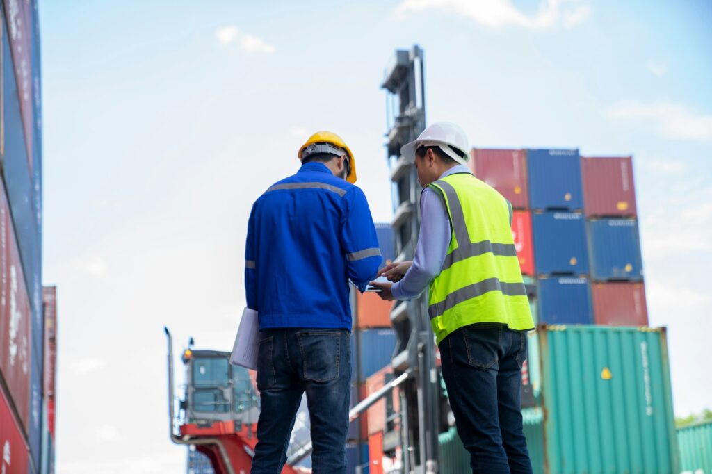 Foreman checking and control loading containers.
